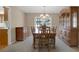 Traditional dining room with wooden table, chairs, buffet, hutch, and a sliding door to the yard at 13186 Linden Place Dr, Seminole, FL 33776