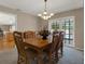 Bright dining area featuring a wooden table set and sliding glass doors to the backyard at 13186 Linden Place Dr, Seminole, FL 33776