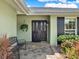 Welcoming front entrance with elegant double doors, brick accents, and decorative plants at 13186 Linden Place Dr, Seminole, FL 33776