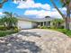 Inviting one-story home with a spacious brick driveway and well-maintained landscaping at 13186 Linden Place Dr, Seminole, FL 33776