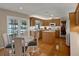 Well-lit kitchen featuring wood cabinets, white countertops, and an island with a view of the outdoor pool at 13186 Linden Place Dr, Seminole, FL 33776
