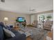 Cozy living room with hardwood floors, comfortable seating, and a television entertainment center at 13186 Linden Place Dr, Seminole, FL 33776