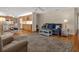 Open-concept living room featuring comfortable seating, ceiling fan and natural light at 13186 Linden Place Dr, Seminole, FL 33776