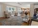 Open-concept living space with hardwood floors, neutral-colored sofas, and easy access to the kitchen at 13186 Linden Place Dr, Seminole, FL 33776
