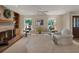 Comfortable living room with a brick fireplace, built-in shelves, and ample seating at 13186 Linden Place Dr, Seminole, FL 33776