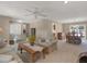 Inviting living room with a ceiling fan and large windows allowing natural light to flow in at 13186 Linden Place Dr, Seminole, FL 33776