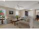 Comfortable living room with classic furnishings, a ceiling fan, and access to the hallway at 13186 Linden Place Dr, Seminole, FL 33776