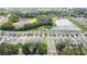 Neighborhood aerial view highlighting the picturesque community with serene pond views and neatly arranged modern homes at 13648 Whiskey Daisy Dr, Dade City, FL 33525