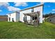 Backyard view with a wooden pergola for outdoor seating and mature landscaping at 13648 Whiskey Daisy Dr, Dade City, FL 33525