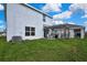 Backyard with well-maintained lawn, wooden pergola and view of the white home exterior at 13648 Whiskey Daisy Dr, Dade City, FL 33525