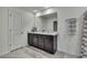 Bathroom featuring a double vanity with dark cabinets and neutral colored countertops at 13648 Whiskey Daisy Dr, Dade City, FL 33525