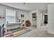 Bright bedroom with a colorful rug, a workspace with a desk and bookshelf, and a walk-in closet at 13648 Whiskey Daisy Dr, Dade City, FL 33525