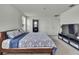 Spacious bedroom featuring a bed with blue and white patterned bedding, and an adjacent bathroom at 13648 Whiskey Daisy Dr, Dade City, FL 33525