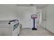 Bright bedroom with neutral walls, carpeted floors, a changing table, toys, and a doorway view to hallway at 13648 Whiskey Daisy Dr, Dade City, FL 33525