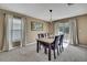 Charming dining area featuring a marble table with seating and sliding glass doors for natural light at 13648 Whiskey Daisy Dr, Dade City, FL 33525
