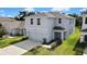 Aerial view of a two-story home with a lush, manicured front lawn at 13648 Whiskey Daisy Dr, Dade City, FL 33525