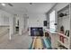 Bright hallway with neutral walls, colorful rug, and doorway views into other rooms and a built-in desk at 13648 Whiskey Daisy Dr, Dade City, FL 33525