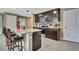 Kitchen featuring dark wood cabinets, tile backsplash, stainless steel appliances, and a tile floor at 13648 Whiskey Daisy Dr, Dade City, FL 33525
