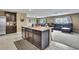 Open floor plan showcasing kitchen with island, seamlessly connected to the cozy living area at 13648 Whiskey Daisy Dr, Dade City, FL 33525