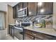 Dark wood cabinetry, tile backsplash, and granite countertops accent this efficiently designed kitchen space at 13648 Whiskey Daisy Dr, Dade City, FL 33525