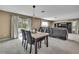 Open-concept living area featuring a marble table and comfortable, oversized leather sofa at 13648 Whiskey Daisy Dr, Dade City, FL 33525