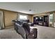 Spacious living room with plush carpet, ample natural light, and a cozy sectional at 13648 Whiskey Daisy Dr, Dade City, FL 33525