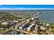 Wide aerial shot showcasing coastal community, bridge, and bay with sailboats, and buildings at 139 Bluff View Dr # 405, Belleair Bluffs, FL 33770