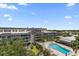 Overhead view of the community pool and meticulously kept landscaping in a picturesque setting at 139 Bluff View Dr # 405, Belleair Bluffs, FL 33770