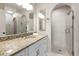 Elegant bathroom featuring granite countertops, white cabinetry, and a luxurious walk-in shower with marble tile at 139 Bluff View Dr # 405, Belleair Bluffs, FL 33770
