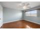 Cozy bedroom with wooden floor, a ceiling fan, and plenty of natural light at 139 Bluff View Dr # 405, Belleair Bluffs, FL 33770
