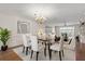 Dining room showcases a modern table setting and decor adjacent to the bright living room at 139 Bluff View Dr # 405, Belleair Bluffs, FL 33770