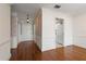 Bright hallway features wood floors, paneled walls, and entry to kitchen at 139 Bluff View Dr # 405, Belleair Bluffs, FL 33770