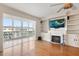 Bright living room with hardwood floors, built-in shelves, and a fireplace for cozy evenings at 139 Bluff View Dr # 405, Belleair Bluffs, FL 33770
