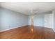 Spacious bedroom with hardwood floors, ceiling fan, and easy access to ensuite bathroom at 139 Bluff View Dr # 405, Belleair Bluffs, FL 33770