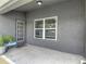 Back patio with large window and door, exterior view at 14371 Edinburgh Moor Dr, Wimauma, FL 33598