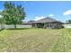 Spacious backyard with lush green grass and a white privacy fence at 14371 Edinburgh Moor Dr, Wimauma, FL 33598