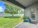 Backyard featuring a mature tree with swing, view from covered patio at 14371 Edinburgh Moor Dr, Wimauma, FL 33598