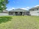 View of backyard and exterior of house, showing lush lawn at 14371 Edinburgh Moor Dr, Wimauma, FL 33598