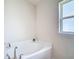 Bathroom features soaking tub and window at 14371 Edinburgh Moor Dr, Wimauma, FL 33598