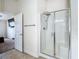 Bathroom features glass enclosed shower stall with seat at 14371 Edinburgh Moor Dr, Wimauma, FL 33598