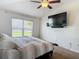 Bright bedroom featuring large window and ceiling fan at 14371 Edinburgh Moor Dr, Wimauma, FL 33598