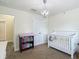 Bedroom features a crib and closet at 14371 Edinburgh Moor Dr, Wimauma, FL 33598