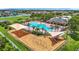 Resort-style community amenities include a sparkling pool, playground, and shaded picnic area for Gathering fun at 14371 Edinburgh Moor Dr, Wimauma, FL 33598