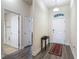 Entryway with front door, hall table, rug, and views into a bathroom with tile floors at 14371 Edinburgh Moor Dr, Wimauma, FL 33598