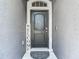 This front entrance features a black door, a welcome sign, and a decorative door mat at 14371 Edinburgh Moor Dr, Wimauma, FL 33598