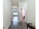 A long hallway with hard flooring leads to other rooms of the home at 14371 Edinburgh Moor Dr, Wimauma, FL 33598