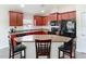 A close up of the kitchen featuring cherry wood cabinets and a peninsula at 14371 Edinburgh Moor Dr, Wimauma, FL 33598