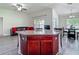 Open-concept kitchen with central island, granite countertops, and seating at 14371 Edinburgh Moor Dr, Wimauma, FL 33598