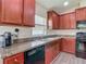 Modern kitchen featuring sleek cabinetry, stainless steel appliances, and ample counter space at 14371 Edinburgh Moor Dr, Wimauma, FL 33598