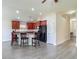 Spacious kitchen featuring a breakfast bar, granite countertops, and stainless steel appliances at 14371 Edinburgh Moor Dr, Wimauma, FL 33598
